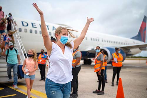 Bonaire's loyal visitors happily disembark after a 15-month wait to return to Bonaire.