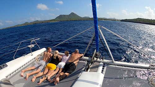 A family relaxing on the Lost Cat private catamaran