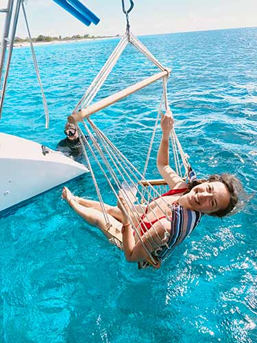 Guests enjoying the swings on the private catamaran
